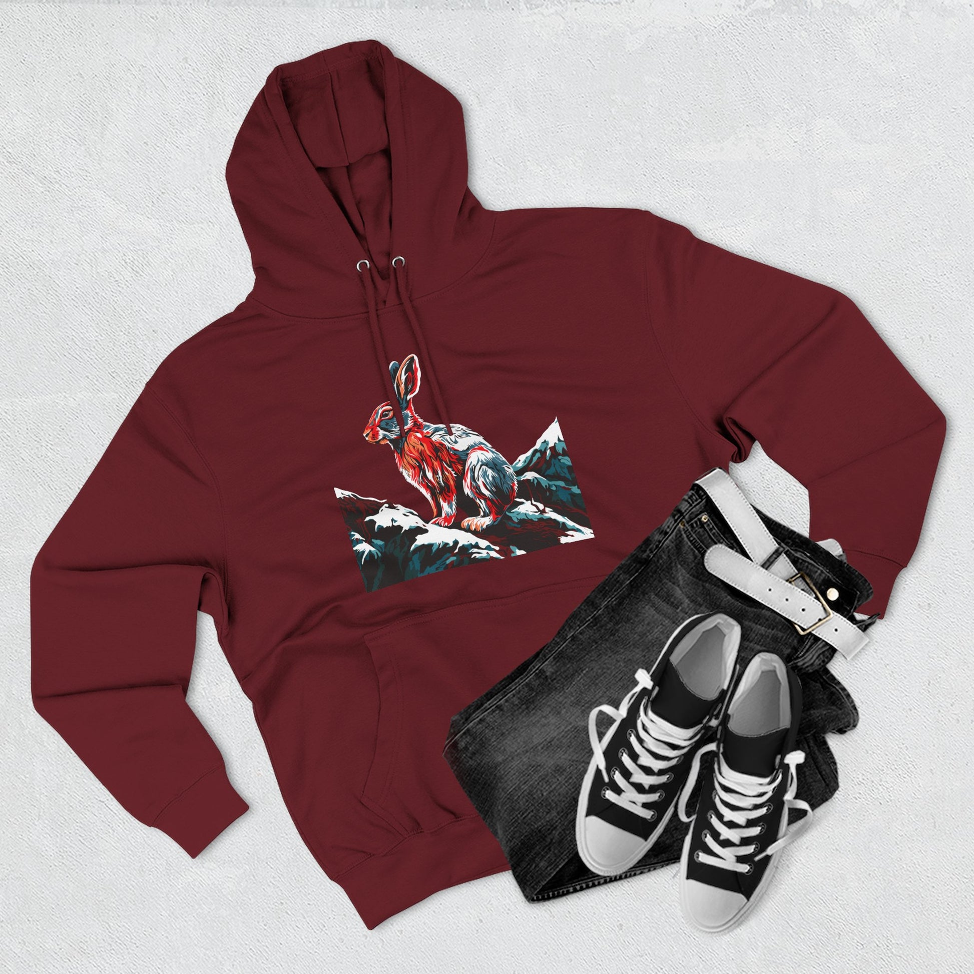 Hand-drawn Alaska Native inspired snowshoe hare hoodie — original Indigenous wildlife design — flat lay view