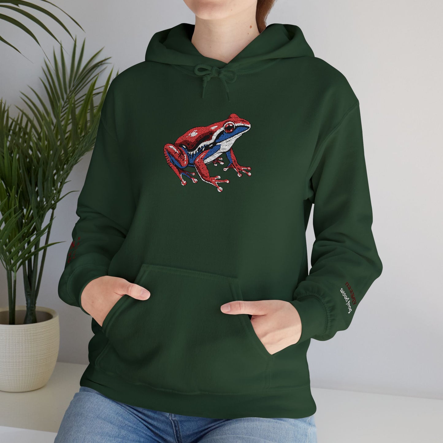 Hand-drawn Alaska Native inspired wood frog hoodie — original Indigenous wildlife design — flat lay view