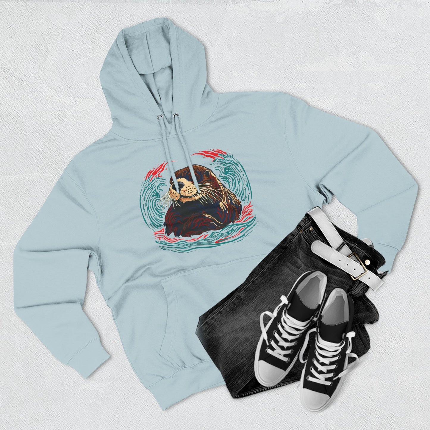 Hand-drawn Alaska Native inspired sea otter hoodie — original Indigenous wildlife design — flat lay view